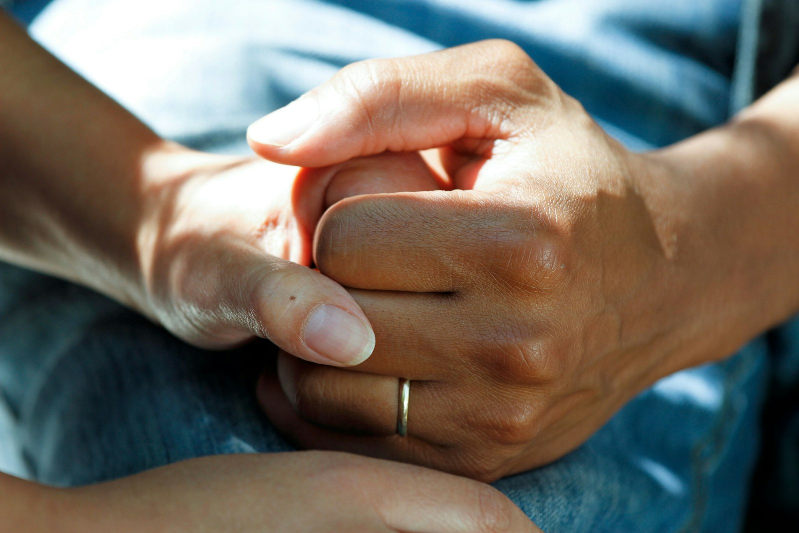Two people holding hands in comfort